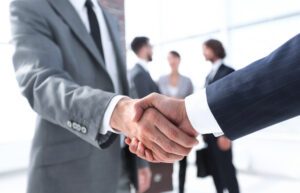 A lawyer shakes hands with a new client. How Can Marketing Strategy Help My Business?